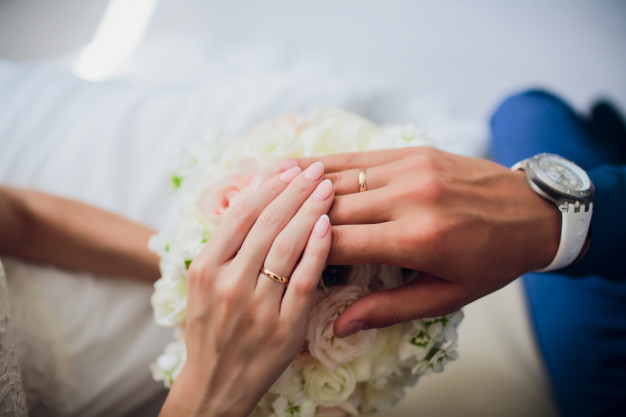 groom-brides-hands-with-rings-closeup-view_152904-3590